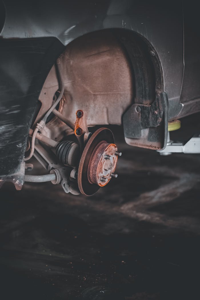 Close-up of a rusty car brake system highlighting repair needs and maintenance.